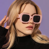 New Retro Square Large Frame Sunglasses Men And Women Trendy worn by model with pink frame and black lenses.
