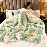Cashmere Three-layer Blanket Thickened Warm Feather Silk Blanket on a bed with a woman relaxing and flower designs.