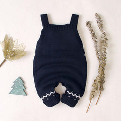 Children's sling Christmas elk jumper on a neutral background with festive decorations.