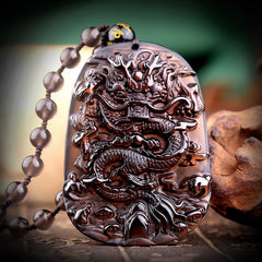 Natural hail black meteorite dragon pendant men's necklace men's pendants lucky transport crystal jewelry on display.