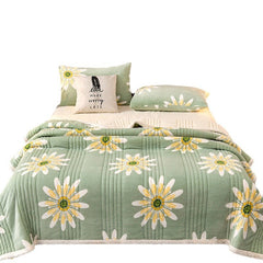 Cashmere Three-layer Blanket Thickened Warm Feather Silk Blanket with floral design on a bed.