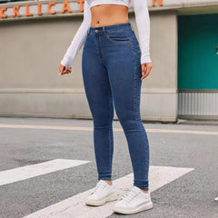 Skinny Stretch Feet Pants Jeans in blue denim, smooth fit, paired with casual white sneakers on urban street.