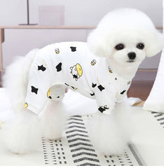 Cotton Cute Pet Pajamas Puppy Dog Clothes Spring And Autumn on a fluffy dog in casual style with a bear and cow pattern.