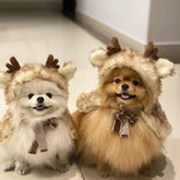 Two adorable pets wearing Christmas Pet Clothing Elk Cape Cloak with antlers and hoods, perfect for festive occasions.