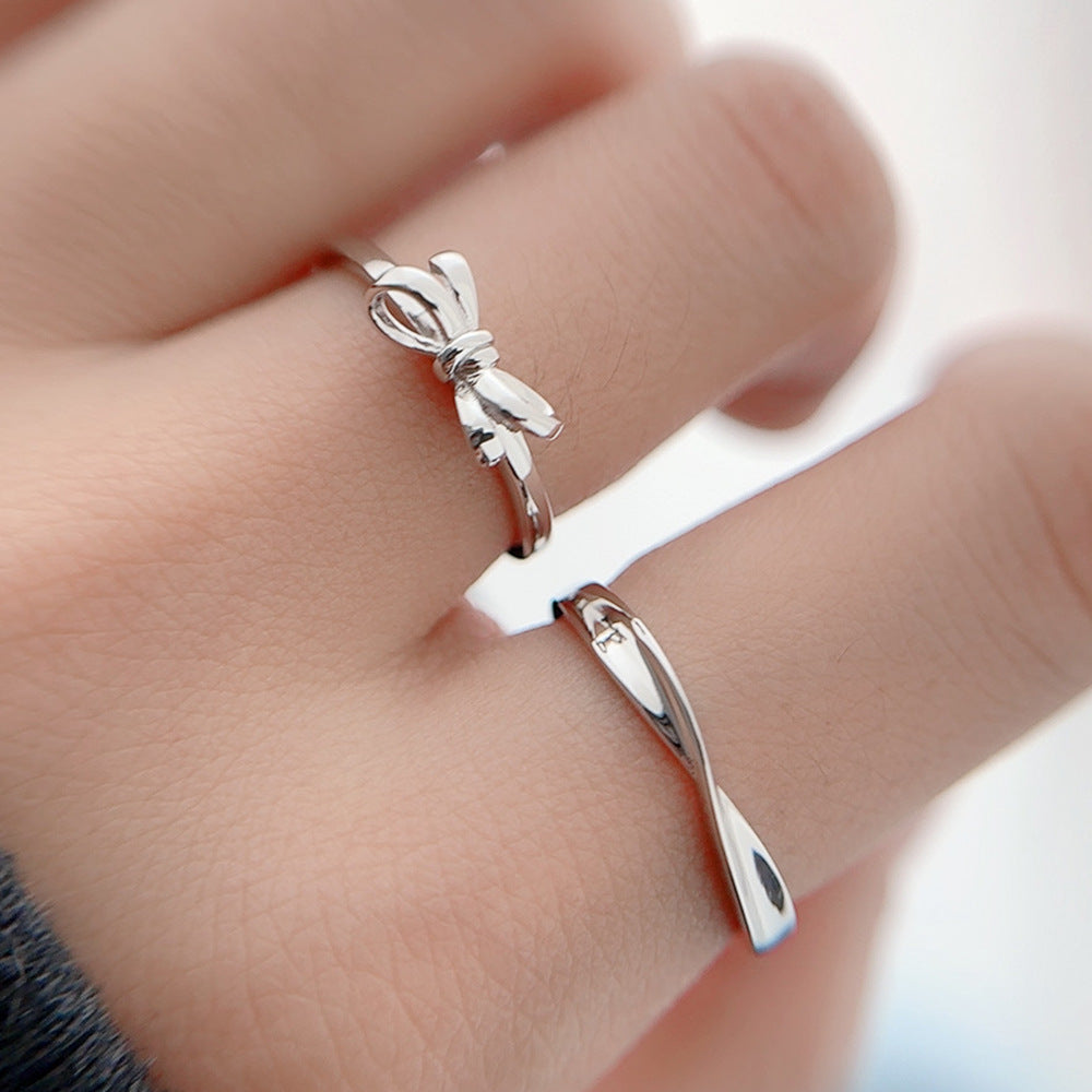 S925 Silver Bow Couple Ring displayed on fingers, featuring an adjustable opening, perfect for fashion jewellery.
