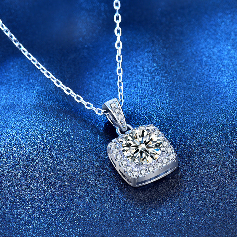 S925 Sterling Silver Jewelry Moissanite Pendant Necklace on blue background, showcasing elegant design and sparkling diamond.
