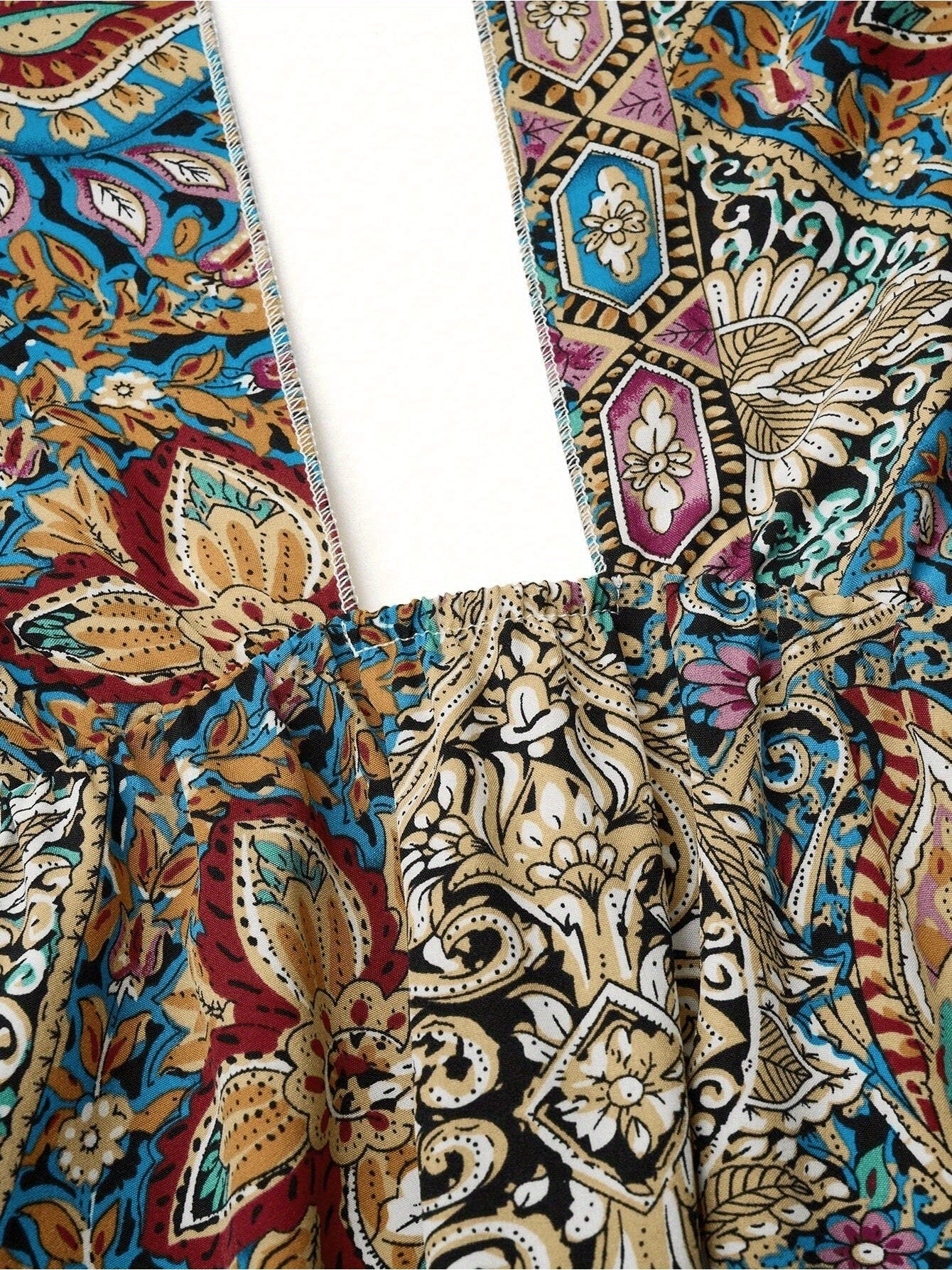 Close-up of the colorful floral pattern on a women maxi dress, showcasing the high waisted design and cross halter neck detail.