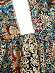 Close-up of the colorful floral pattern on a women maxi dress, showcasing the high waisted design and cross halter neck detail.
