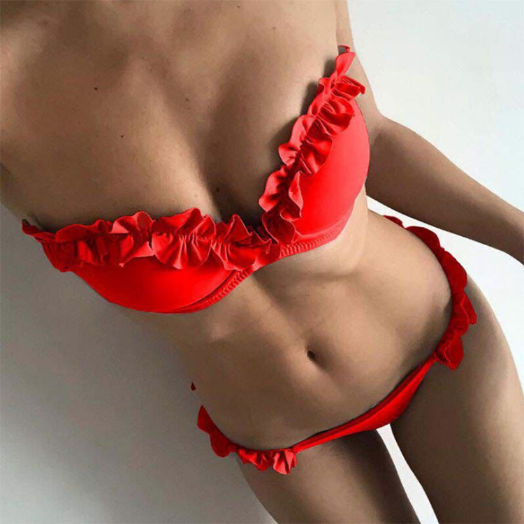Women's strapless solid color swimsuit in vibrant red with ruffle detail, ideal for swimming and beachwear.