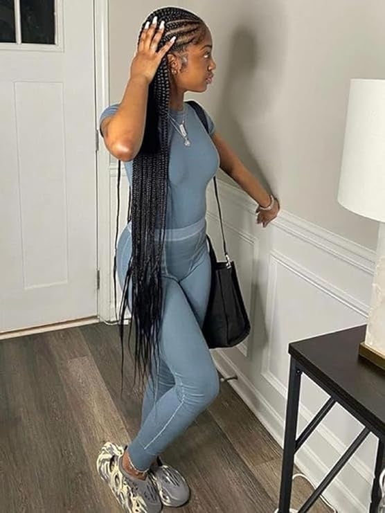 Model wearing fashionable Short Sleeved Pants set with long pants and a short sleeve top, styled with accessories.