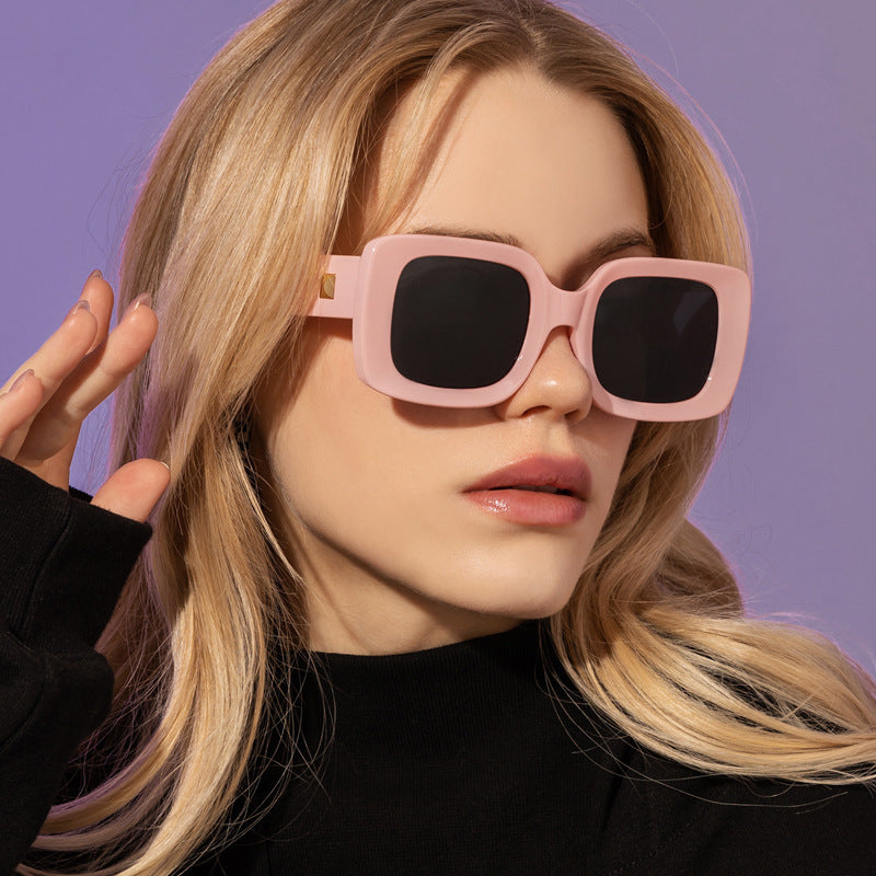 New Retro Square Large Frame Sunglasses Men And Women Trendy worn by model with pink frame and black lenses.