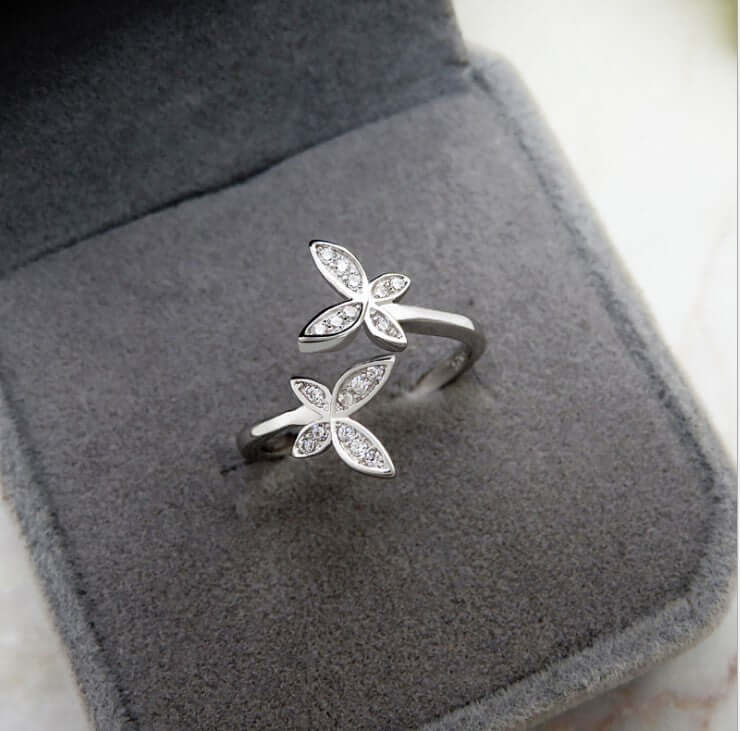 Sterling Silver Adjustable Butterfly Ring displayed on grey velvet box, featuring silver mosaic design and gems.