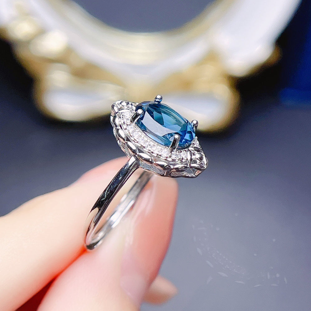 Jewelry Natural Topaz Ring S925 Silver with a blue topaz gemstone and sparkling accents on a polished silver band.