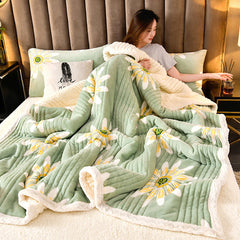 Cashmere Three-layer Blanket Thickened Warm Feather Silk Blanket on a bed with a woman relaxing and flower designs.
