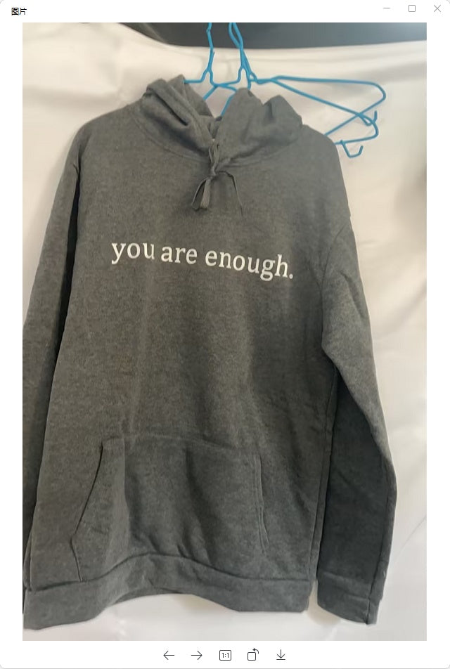 printed hoodie with pockets in gray featuring the phrase 'you are enough' on the front.
