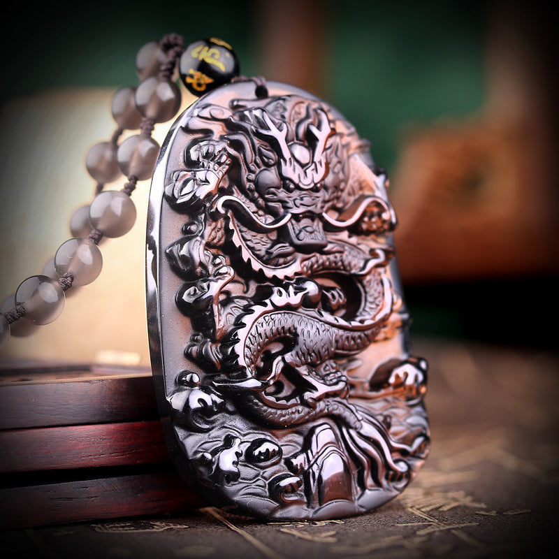 Natural hail black meteorite dragon pendant men's necklace men's pendants lucky transport crystal jewelry on display.