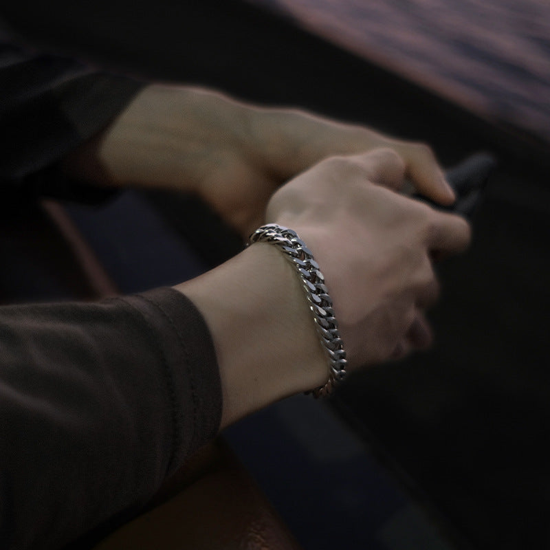 Close-up of a hand wearing a stylish Titanium steel bracelet, showcasing fashion jewellery and a geometric design.
