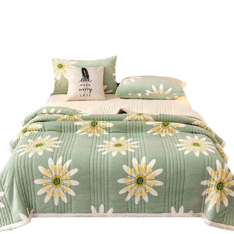 Cashmere Three-layer Blanket Thickened Warm Feather Silk Blanket with floral design on a bed.