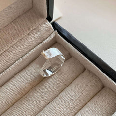 S925 Sterling Silver Brushed Pearl Ring For Women displayed in a jewelry box, showcasing its sleek design and pearl accent.