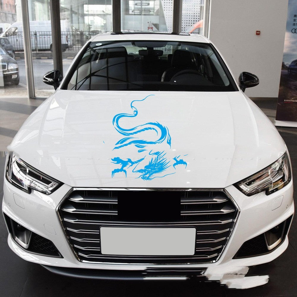 Car sticker modification front end featuring a blue dragon design on a white car.
