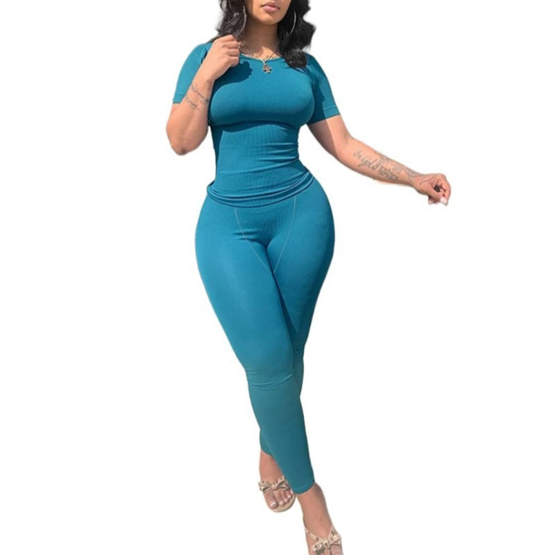 Model wearing Short Sleeved Pants in teal color, showcasing a fitted short sleeve top and long pants.