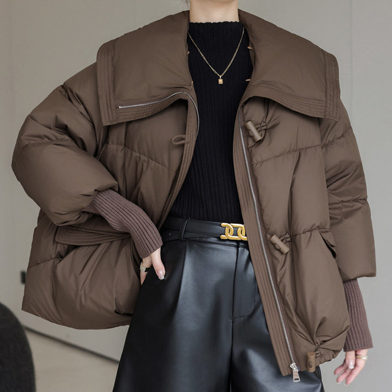 Down Cotton-padded Jacket Women's Short Fur Collar Thickened Coat in brown worn with a black sweater and stylish pants.