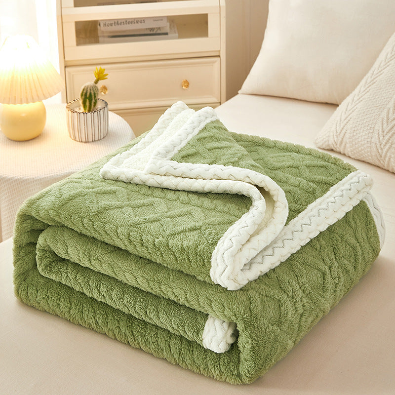 Blanket Double Thickened Warm Coral Fleece Sofa Blanket in green on a sofa for winter warmth.