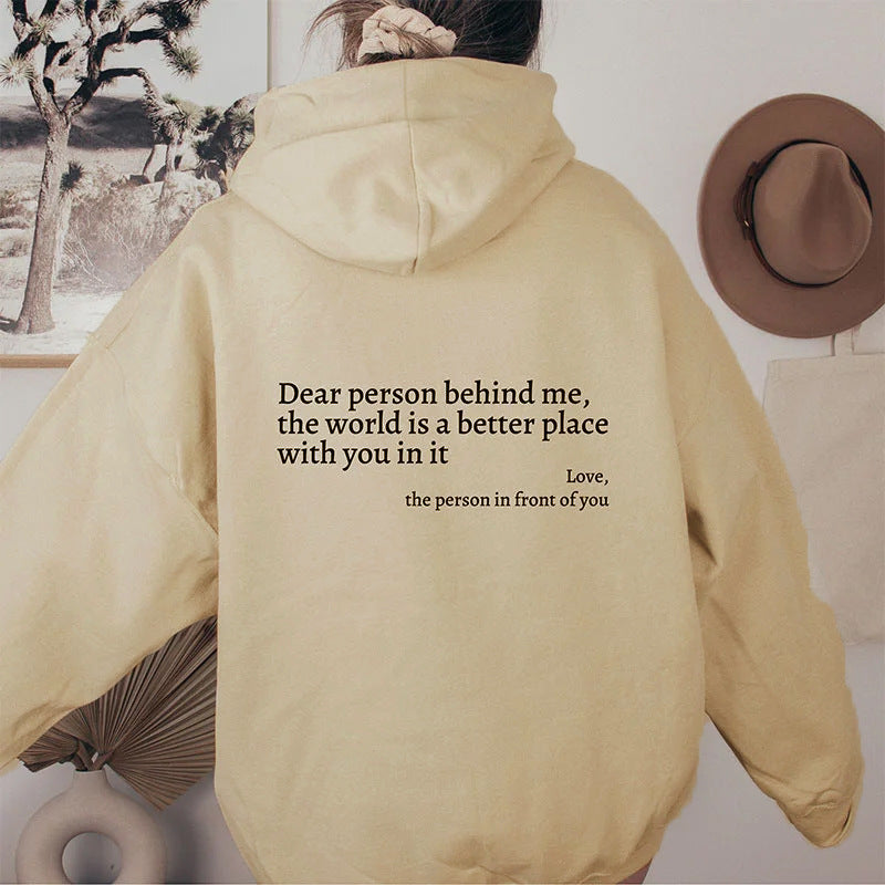 printed hoodie with pockets featuring a meaningful quote on the back in a soft beige color.
