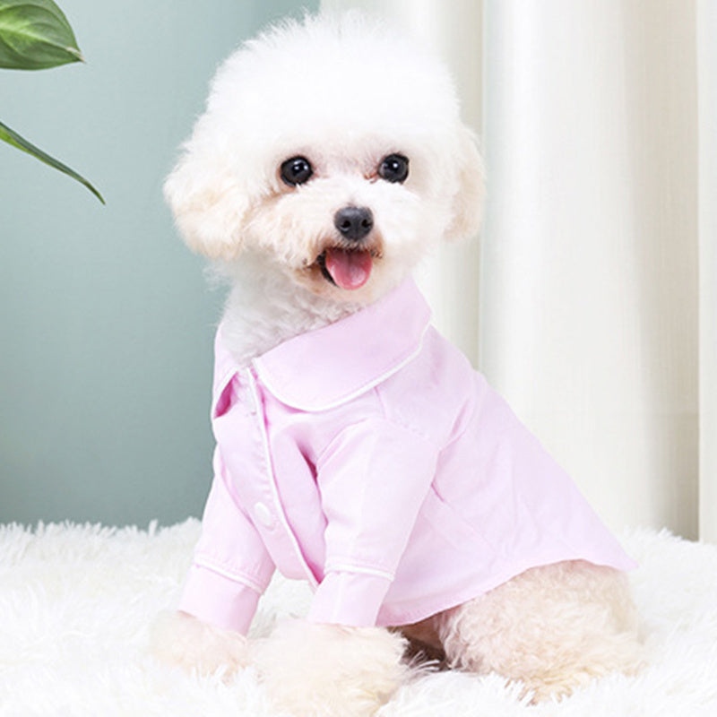 Cute dog wearing French Small Incense Style Fighting Pet Clothes Dog Pajamas in pink color.