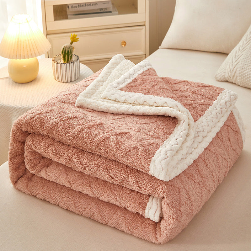 Blanket Double Thickened Warm Coral Fleece Sofa Blanket in soft peach color folded on a couch.