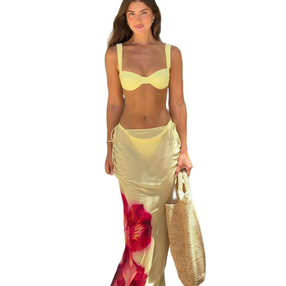 Three-piece Bikini Printed Split Women's Swimsuit Suit in yellow, model showcasing trendy beach style with a floral wrap skirt.