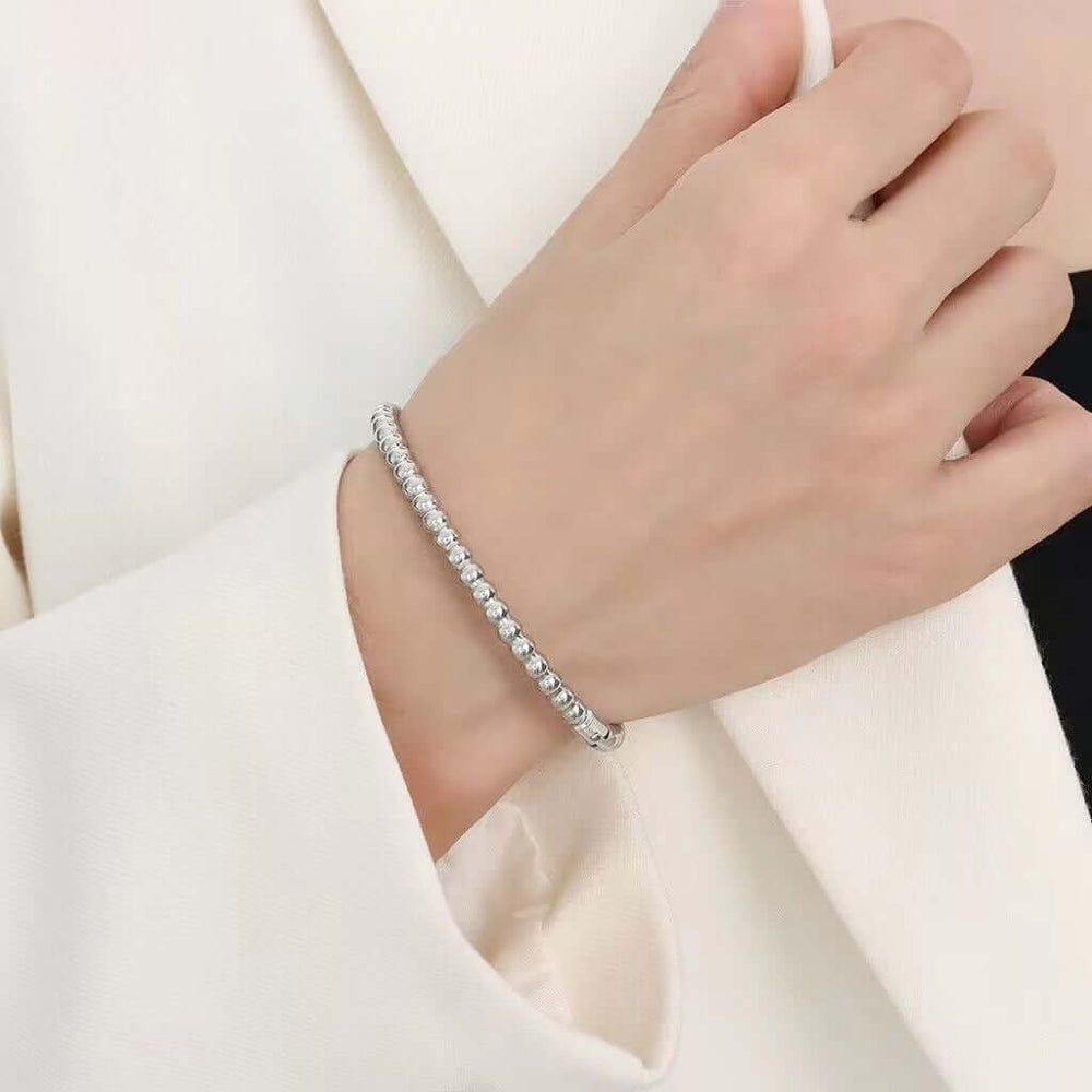 Titanium Steel Round Beads Stainless Steel Bracelet showcased on a hand wearing a stylish outfit, perfect for fashion jewellery.