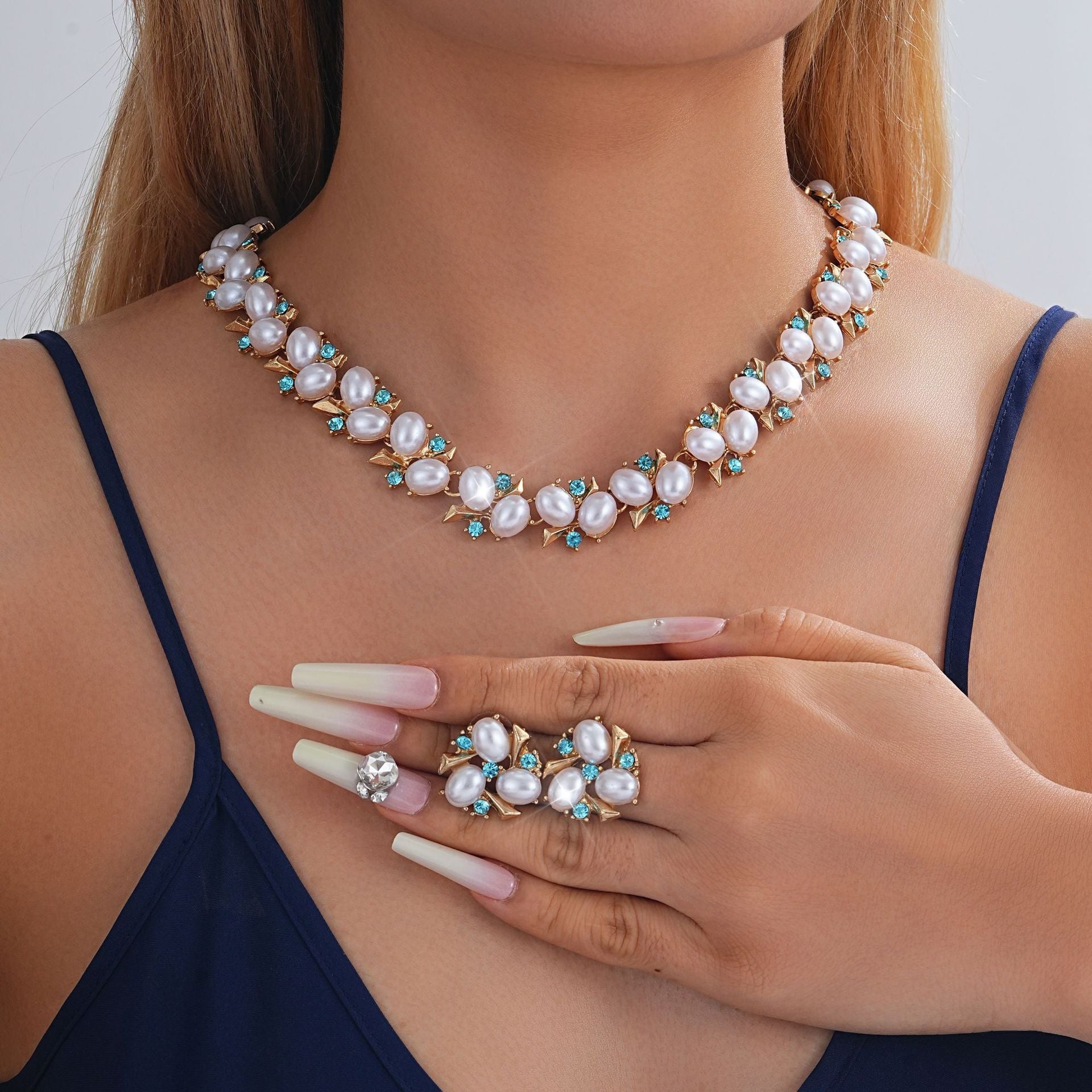 Turquoise Pearl Necklace And Earrings Suite worn by a model showcasing fashion jewellery for a stylish look.