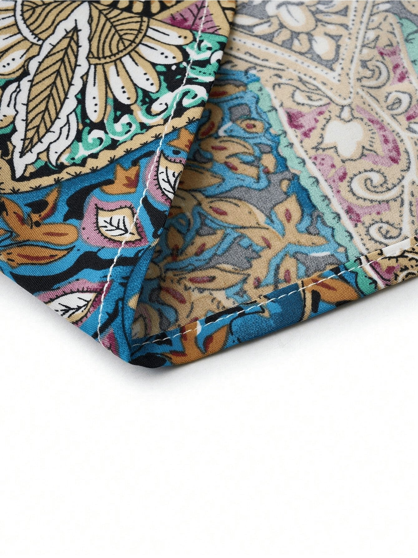 Close-up of the fabric pattern of a women maxi dress, showcasing vibrant colors and detailed tropical design.