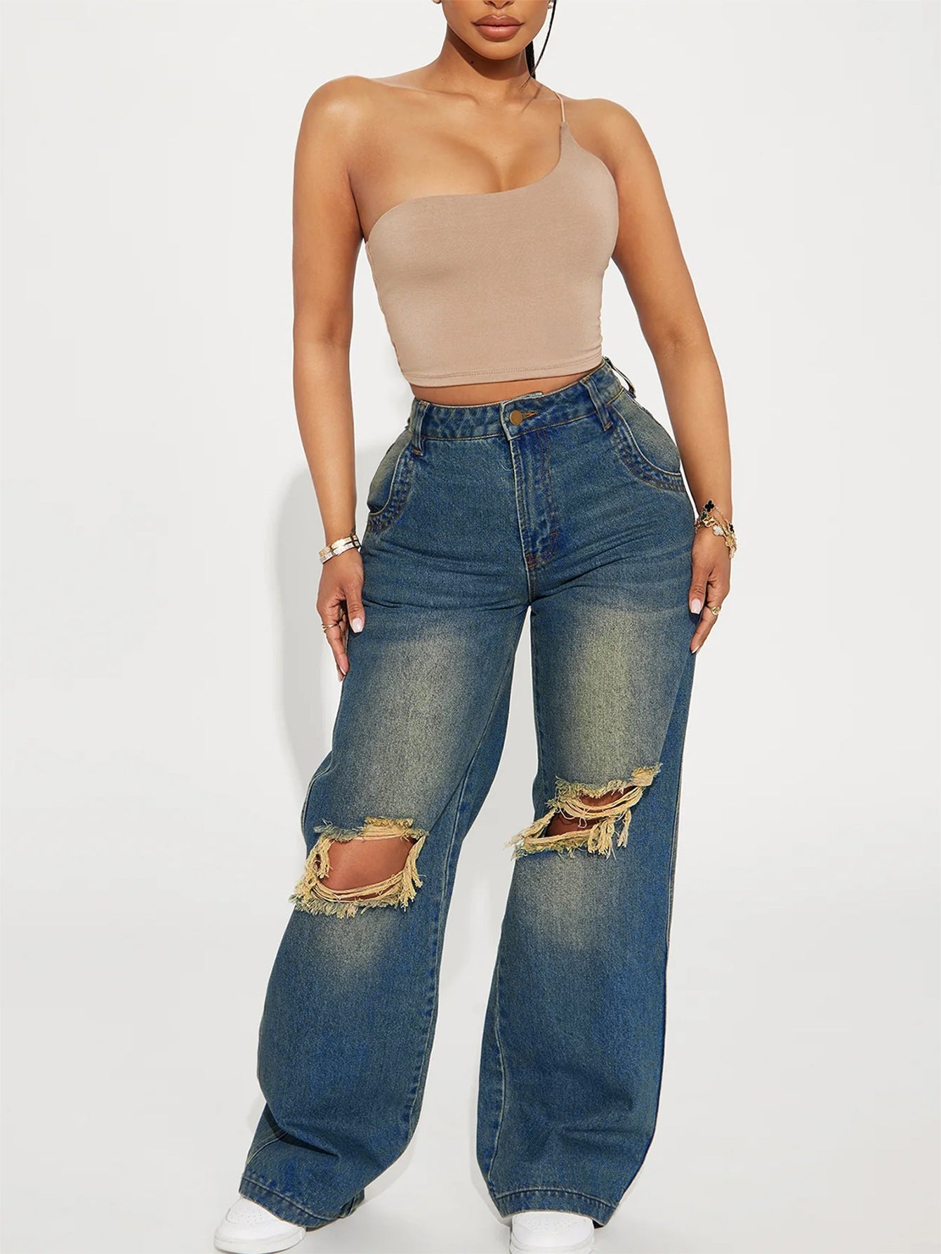 Woman wearing Retro Heavy-duty Washed Knee Ripped Wide-legged Jeans paired with a stylish top.