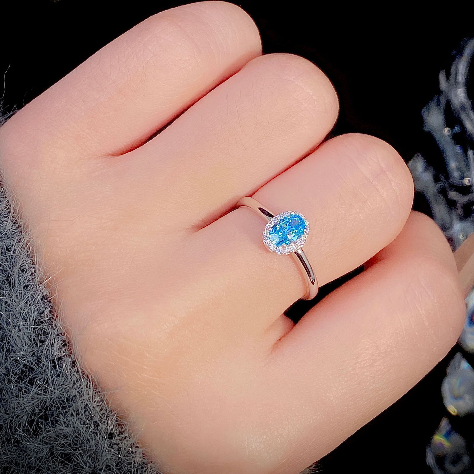 S925 Sterling Silver Ring Female Niche Advanced on a hand with blue stone, fashion jewellery for Christmas.