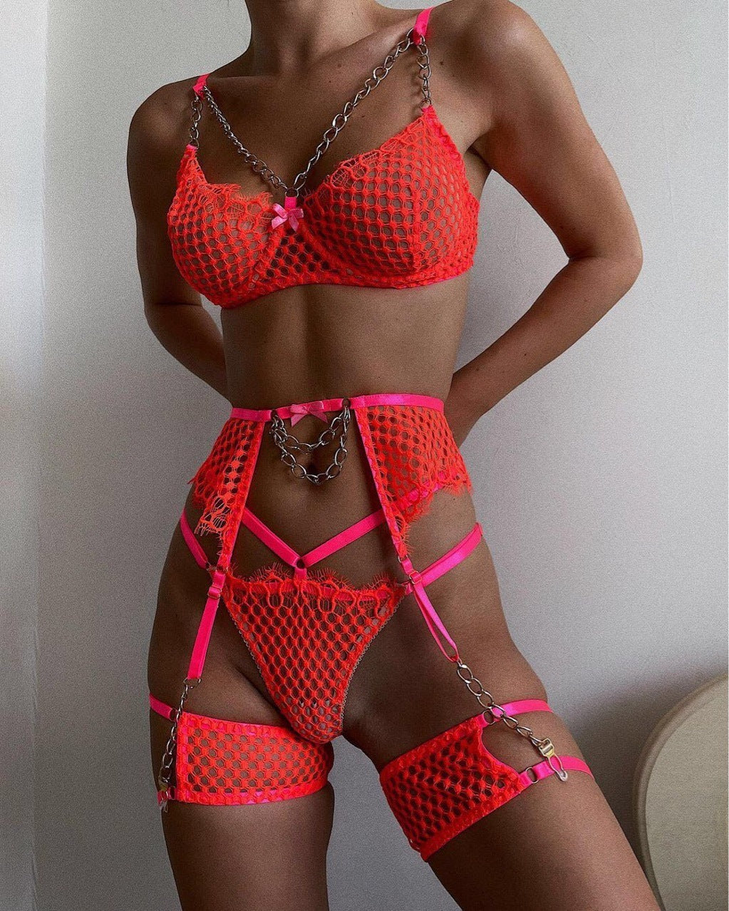 Chain Buds Hanging Grid Perspective lingerie in neon orange featuring chains and sheer mesh design.