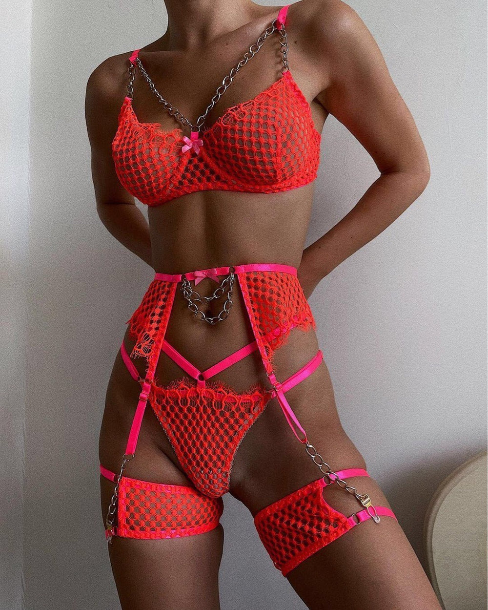 Chain Buds Hanging Grid Perspective lingerie in neon orange featuring chains and sheer mesh design.