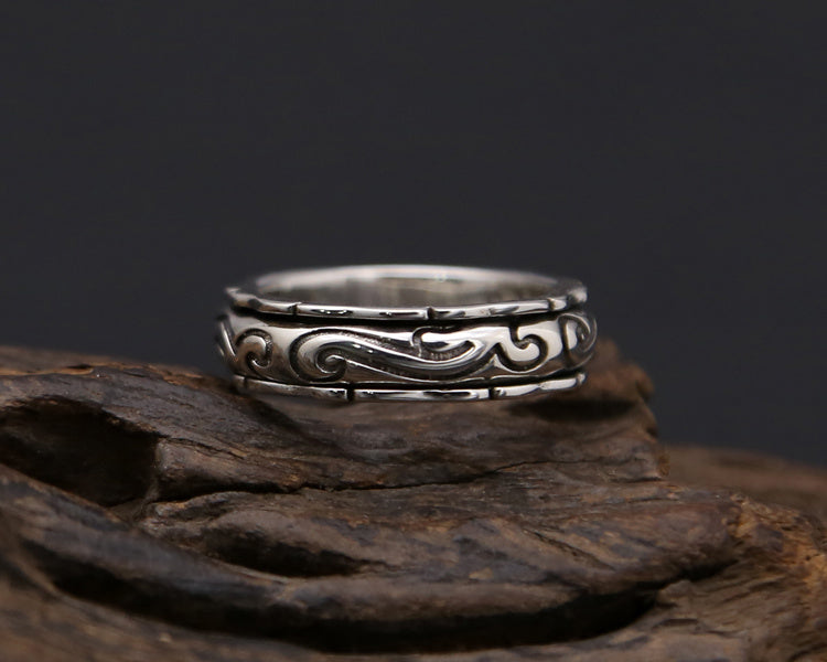 S925 Sterling Silver Jewelry Ring featuring intricate swirling designs on a wooden display.